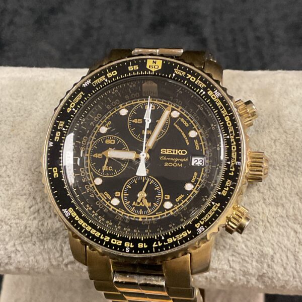 Vintage Seiko quartz chronograph watch with gold tone.