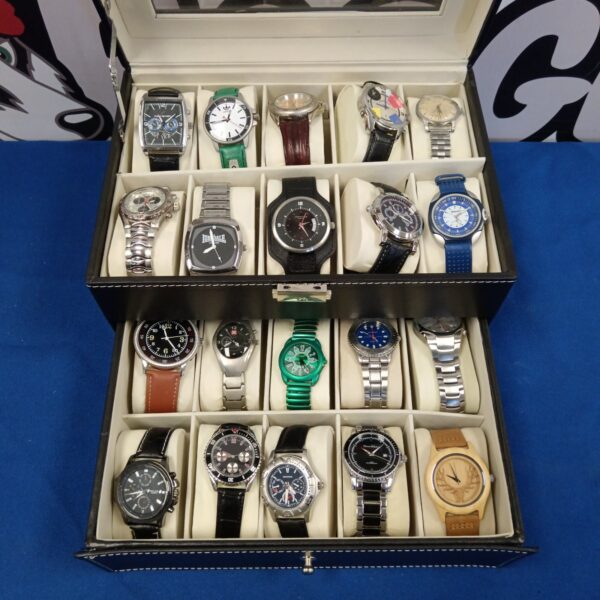 Assorted Sekonda and Identity watches in a display case.