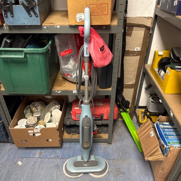 Shark floor polisher with spare pads, cleaning appliance for hard floors.