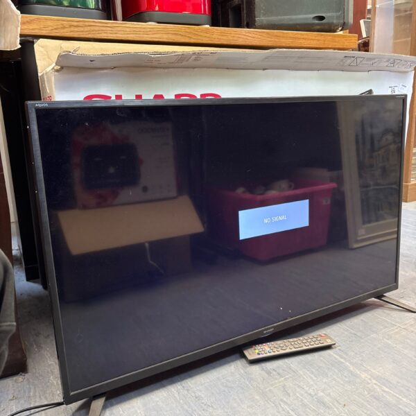 Sharp 40 inch LED TV with remote control for home entertainment.