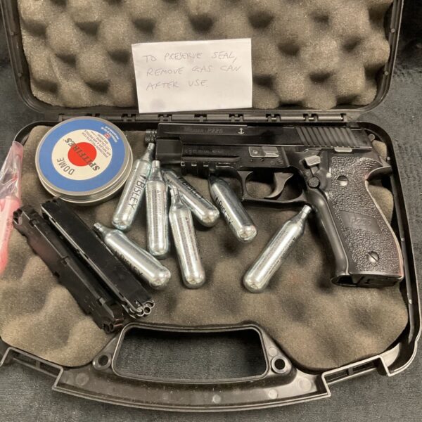 Sig Sauer P226 CO2 pistol in open case with accessories.