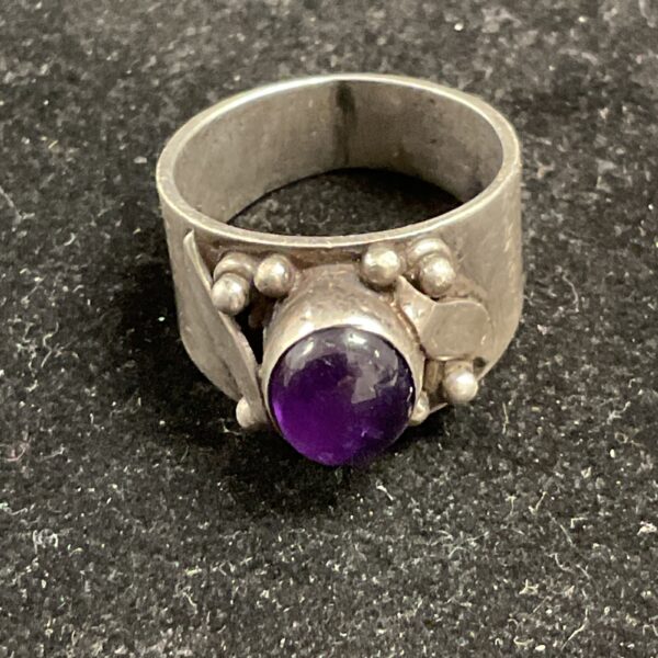 Silver ring with a vibrant amethyst stone, size O.