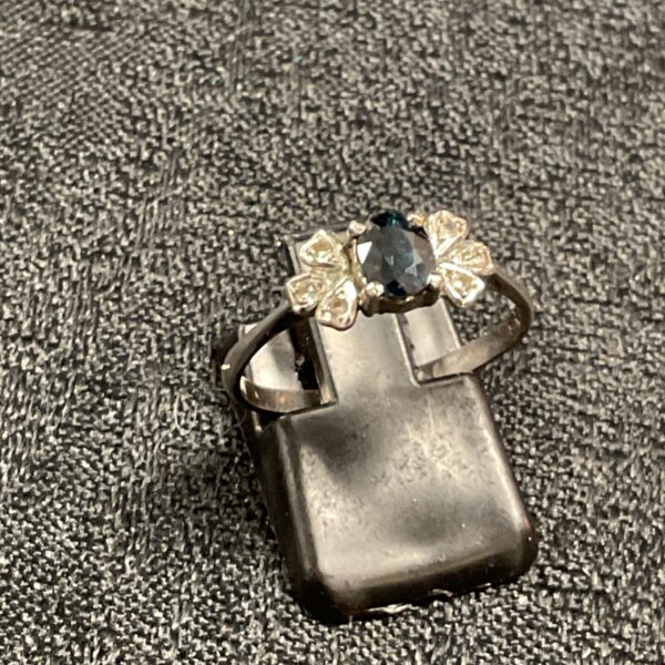 Silver ring with dark blue stone and white accents, size P.