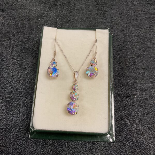 Silver crystal necklace and earring set with iridescent pendant.