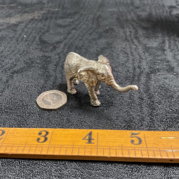 Detailed silver elephant figurine, collectible animal sculpture.