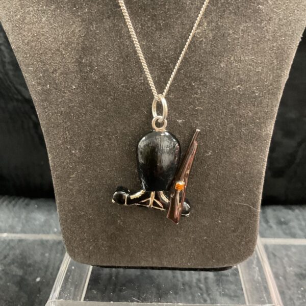 Detailed silver guardsman pendant on a silver necklace.