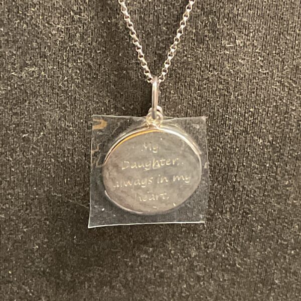 Silver heart pendant necklace with "My daughter" inscription.