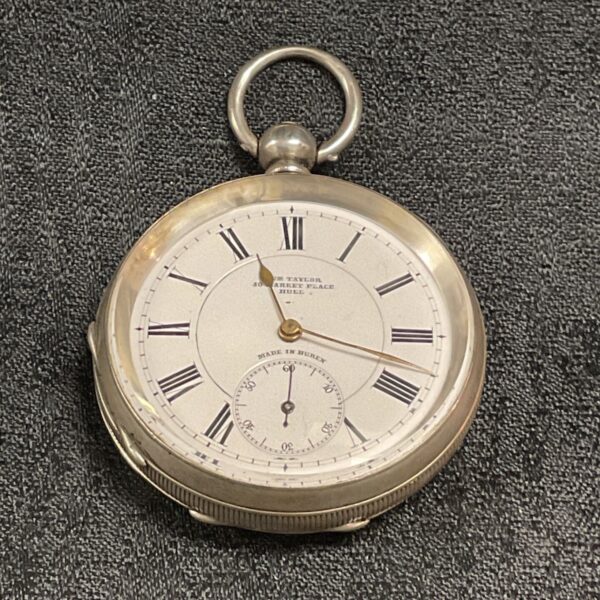 Antique silver pocket watch with white dial and Roman numerals.