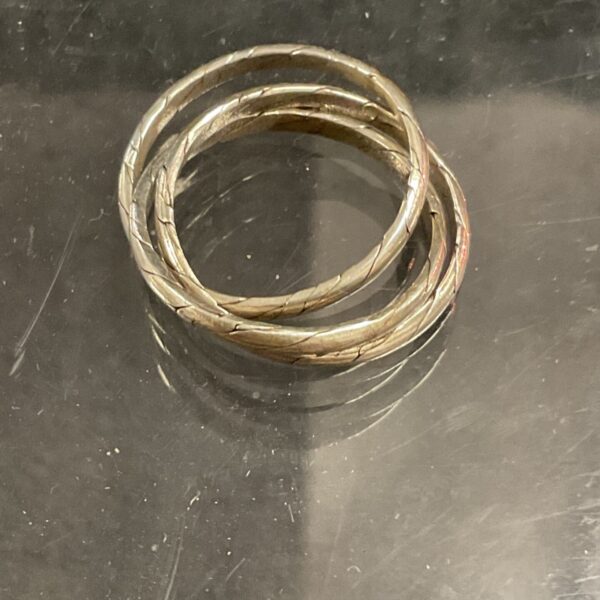 Close-up of a silver puzzle ring, size O.