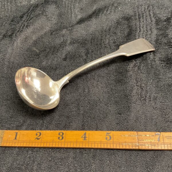 Antique silver sauce ladle by James Dixon & Son, detailed view.