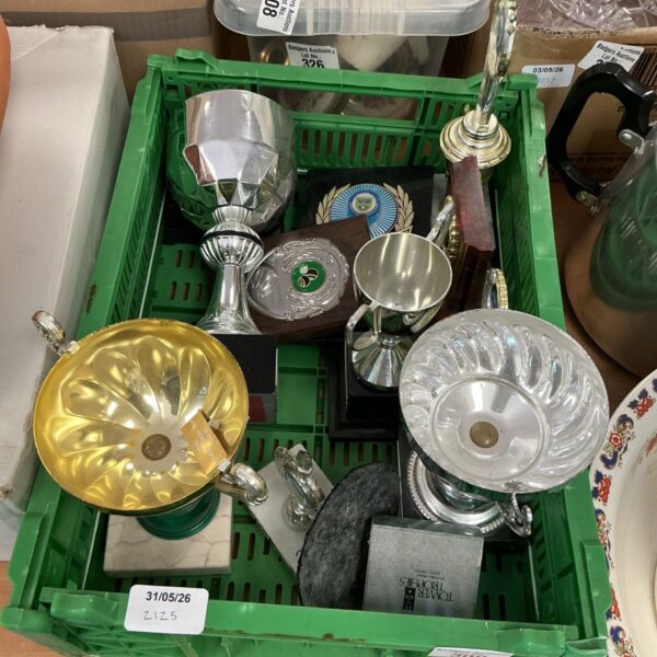 Vintage silver plated trophies and bowls on display.