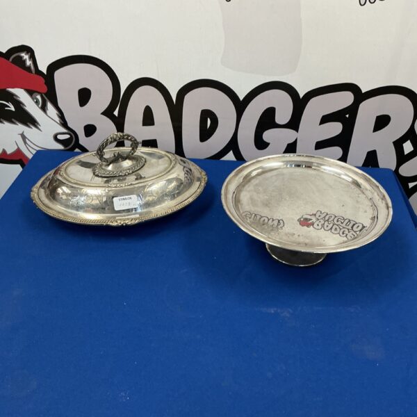 Ornate antique silverplate tureen and cake stand set on display.