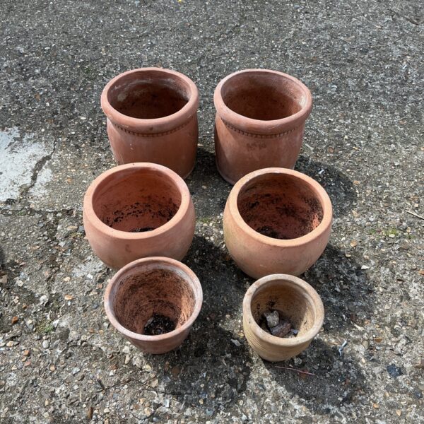 Six vintage terracotta planters for garden use.