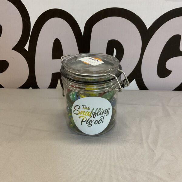 Snaffling Pig Co marble jar filled with colourful glass marbles.