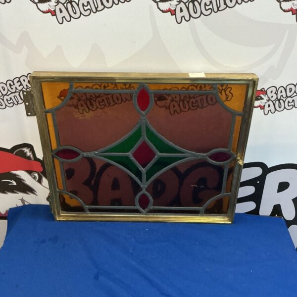 Vintage stained glass window with copper frame and floral design.