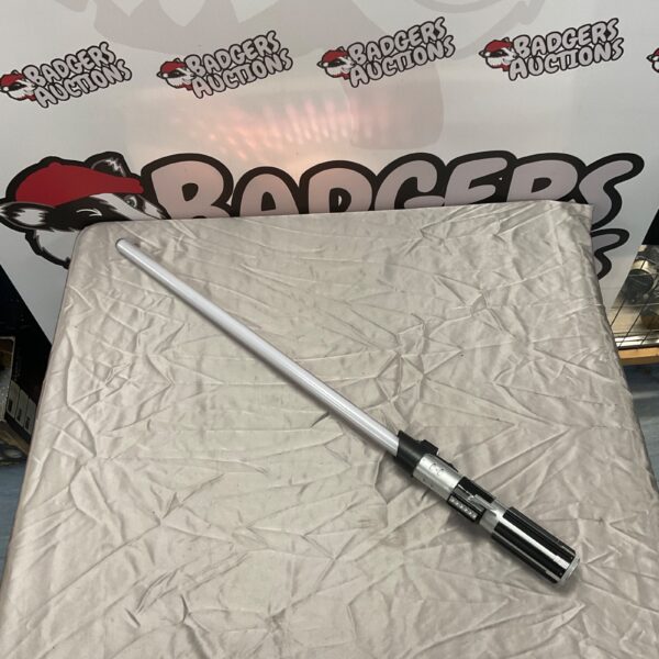 Electronic Star Wars lightsaber with silver hilt and illuminated blade.