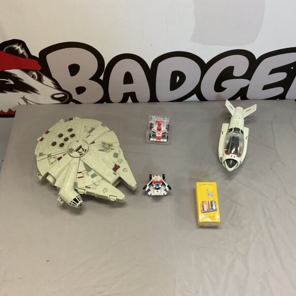 Vintage Star Wars Millennium Falcon toy lot with other collectibles.
