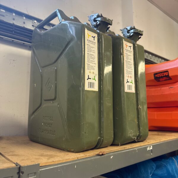 Pair of vintage steel jerry cans for fuel or water storage.