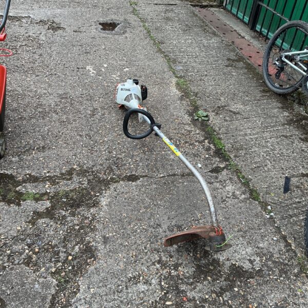 Used Stihl petrol strimmer in a garden setting, ideal for restoration.