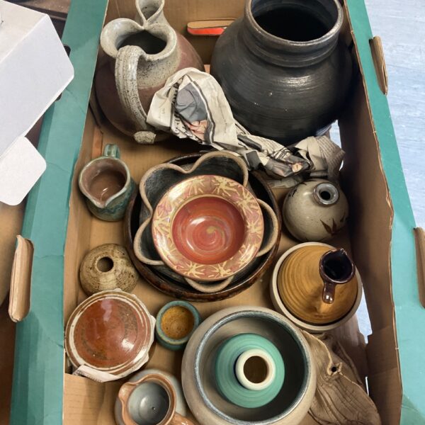 Mixed studio pottery collection on a tray, handmade ceramics.