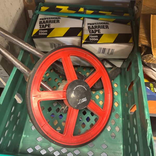 Forge steel surveyors wheel with barrier tape rolls for distance measurement.