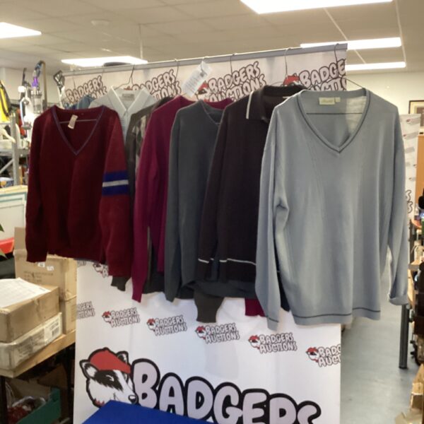 Assortment of sweaters and polo shirts in various colours.