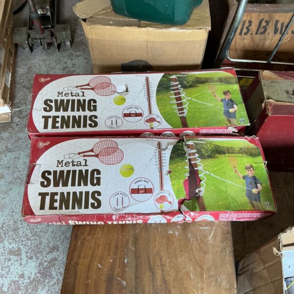 Two vintage Swing Ball sets in a garden setting.