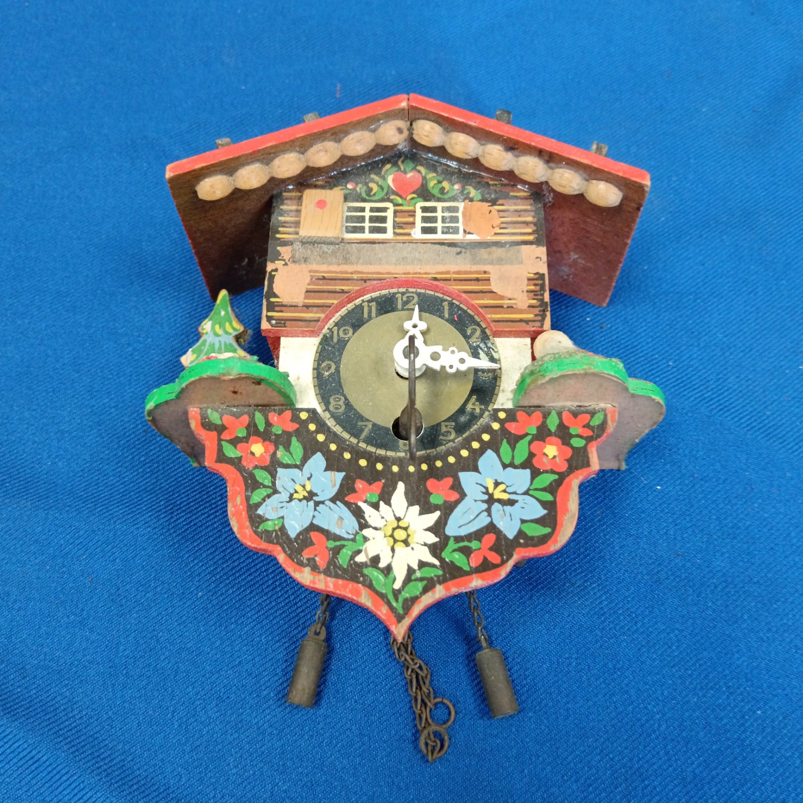 Vintage Swiss cuckoo clock with chalet detailing.