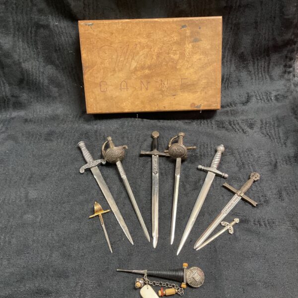 Vintage sword letter opener set displayed with decorative box.