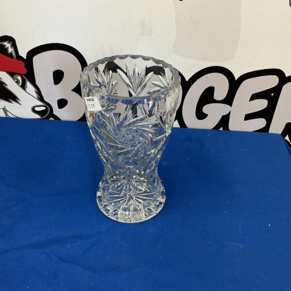 Tall crystal vase with detailed cut glass design.