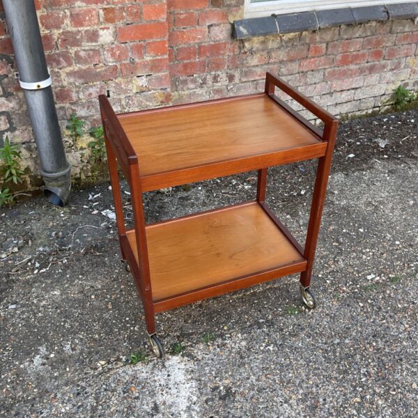 Vintage teak drinks trolley with two tiers and castors.