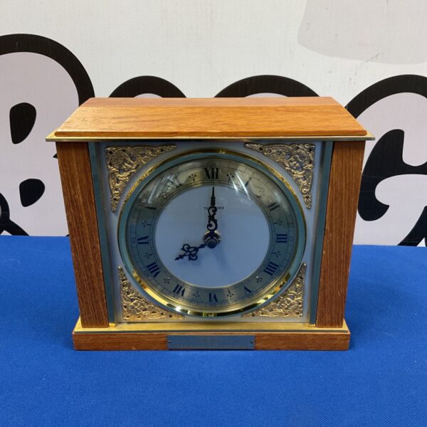 Vintage Tempora mantle clock with oak case and blue dial.