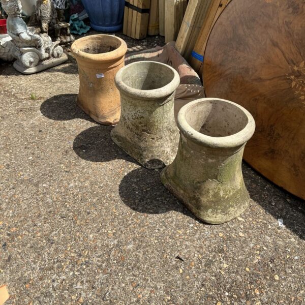 Lot of three weathered terracotta chimney pots for garden use.