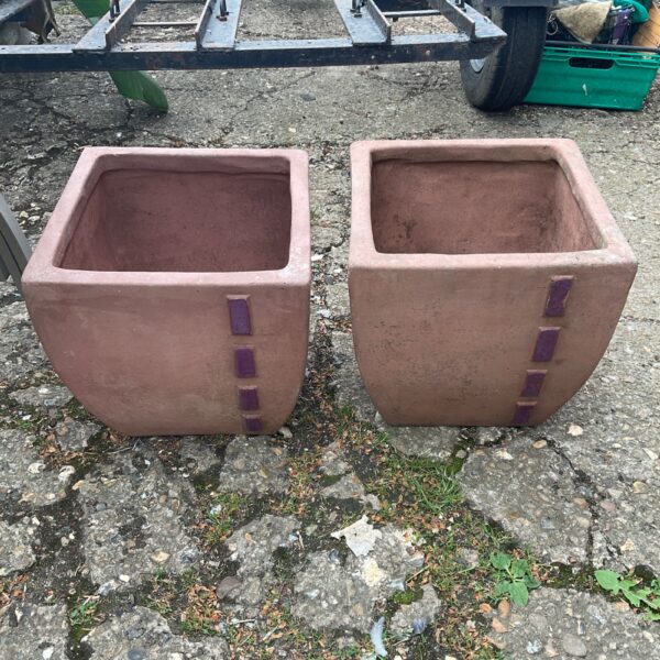 Pair of rustic terracotta garden planters for outdoor plants.