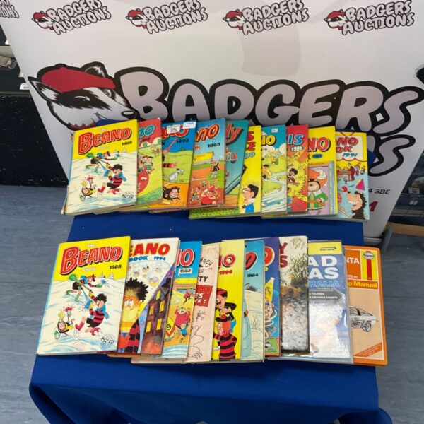 Collection of vintage The Beano Book annuals, colourful covers visible.