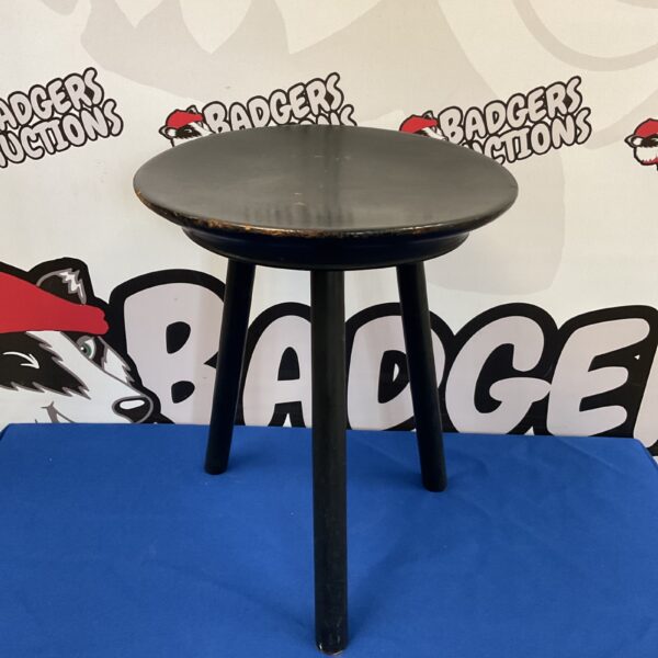 Rustic three legged wooden stool for farmhouse decor.