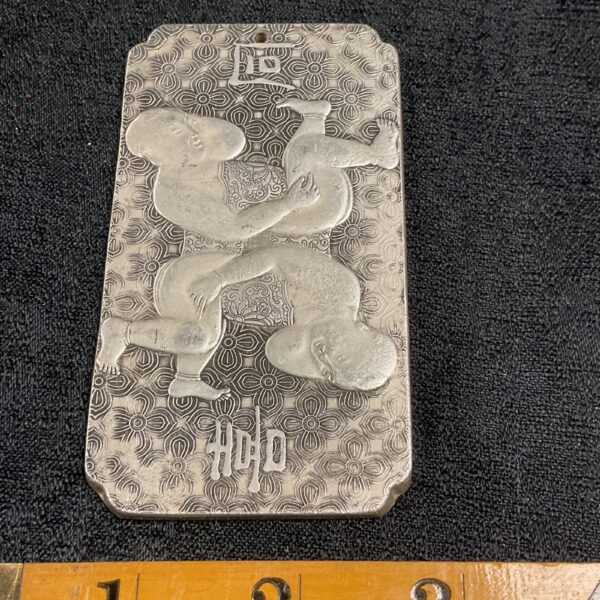 Antique Tibetan silver pwaist tag with dragon embossing.