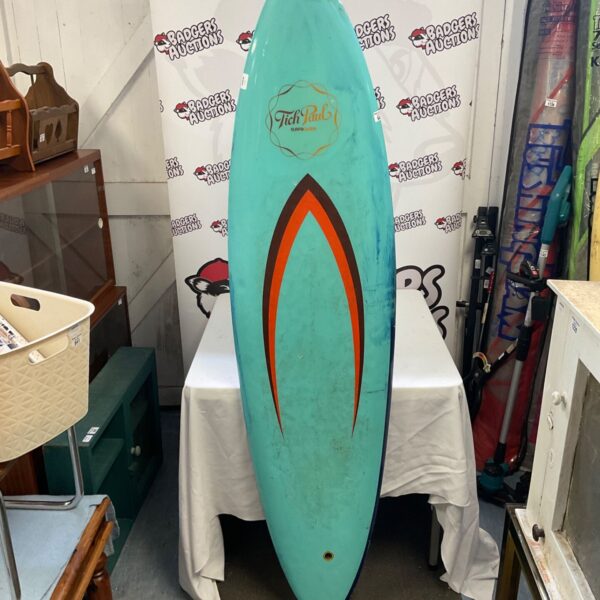 Vintage Tich Paul surfboard with teal and red design.