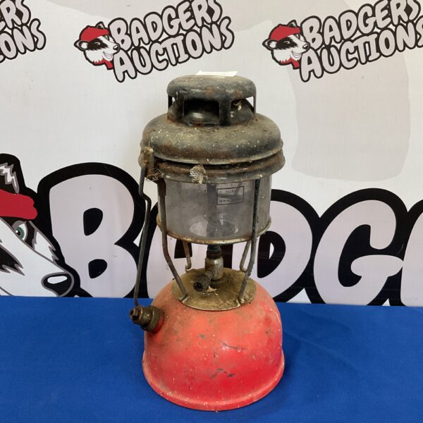Vintage red enamel Tilley paraffin lamp, a classic collectible lighting piece.