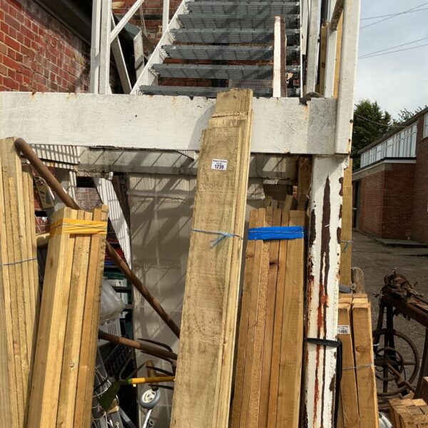 Three bundles of timber in a garden setting, ready for DIY projects.