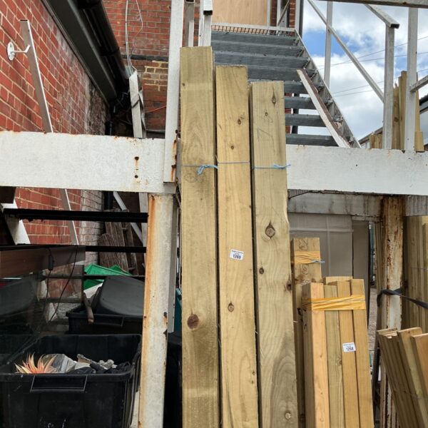 Three bundles of 7’6” timber stacked outdoors, ready for use.