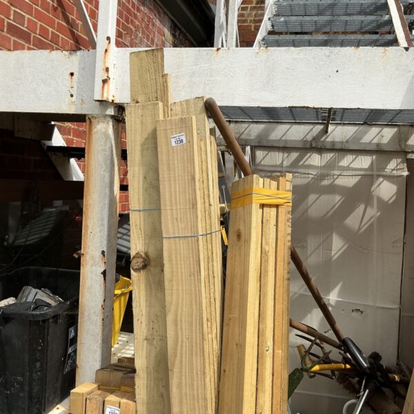 Three bundles of 7ft timber stored outdoors, ready for use.