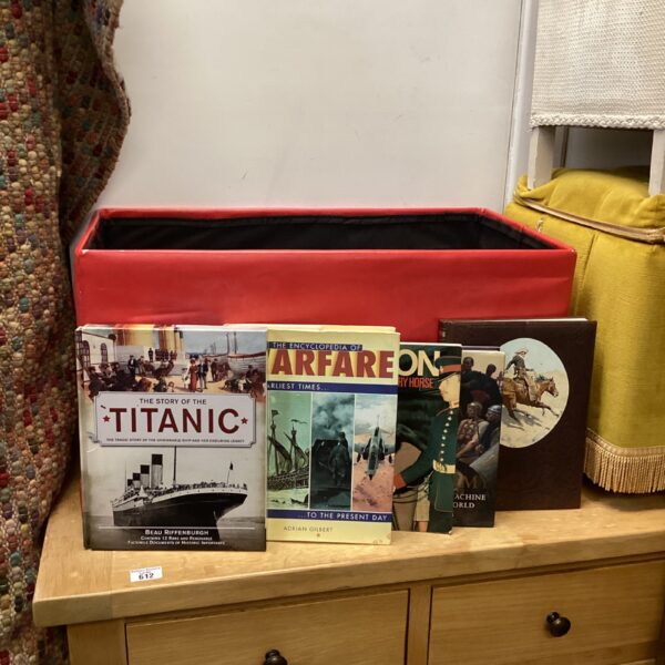 Red box filled with Titanic and warfare history books.