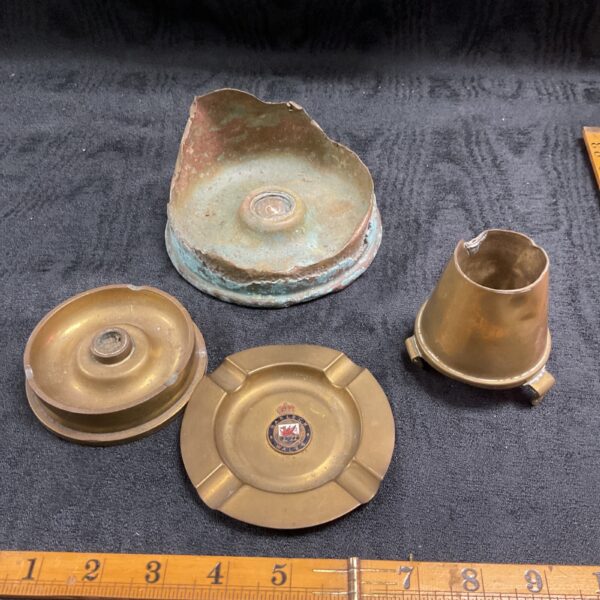 Vintage trench art shell ashtrays, including a Harlech Wales marked piece.