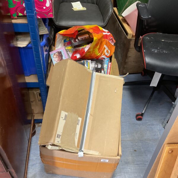 Large collection of VHS tapes in cardboard boxes.