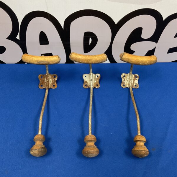 Set of three antique Victorian brass coat hooks.