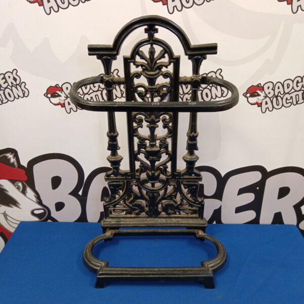 Ornate Victorian cast iron stick stand with floral details.