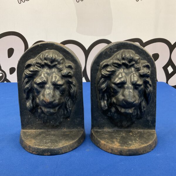 Antique Victorian cast iron lion bookends, detailed lion head sculpture.