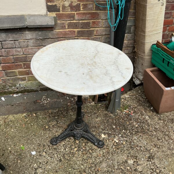 Antique Victorian marble top table with cast iron base.