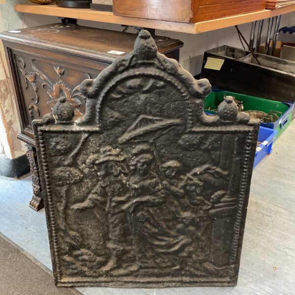Victorian cast iron fireplace back plate with detailed tavern scene relief.